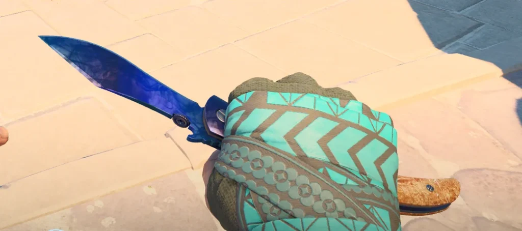 a Navaja knife in hand with colorful gloves