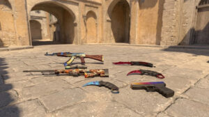 Some of the best CS2 patterns displayed on popular weapons on the floor of a dusty CS2 map